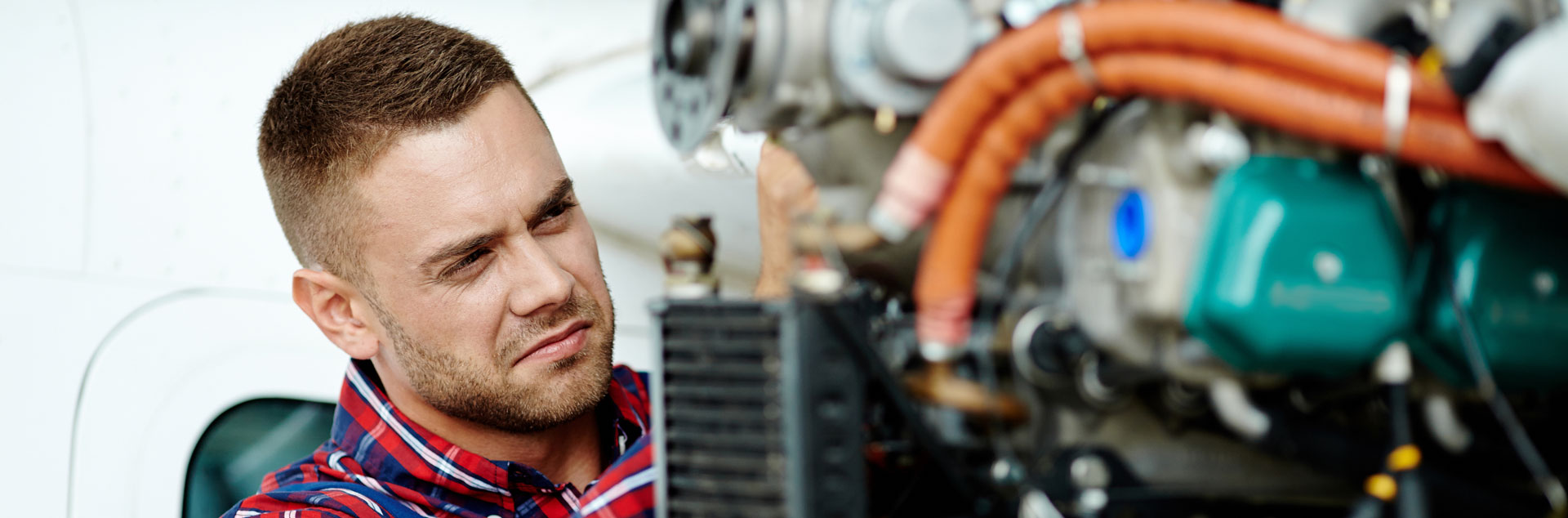 MRO: Mechanic works on aircraft engine. 